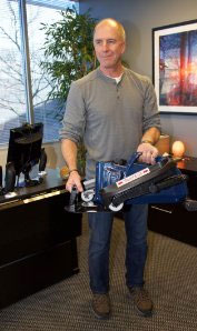 Man Carrying Under Desk Elliptical Machine